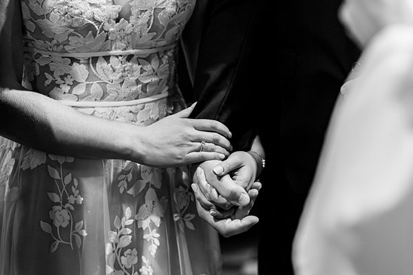 Couple holding hands during wedding ceremony