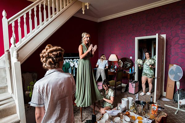 Bridesmaids preparing in a room before a wedding.