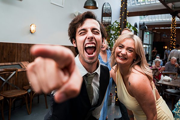 Joyful people celebrating at a lively indoor event.
