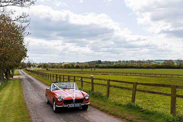 Vintage red car on countryside road
