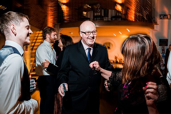 Group of people laughing at a social event.