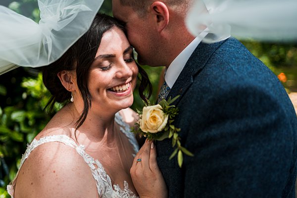 Bride and groom smiling on their wedding day