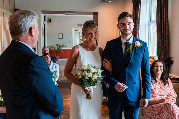 Wedding ceremony with happy couple and guests.