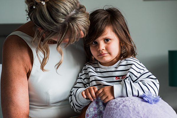 Woman and child sitting together indoors.