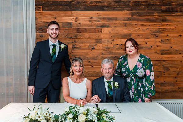 Family celebrating a wedding with floral decorations.