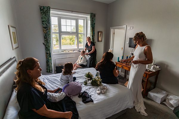 Wedding preparation in a bright room with bridesmaids