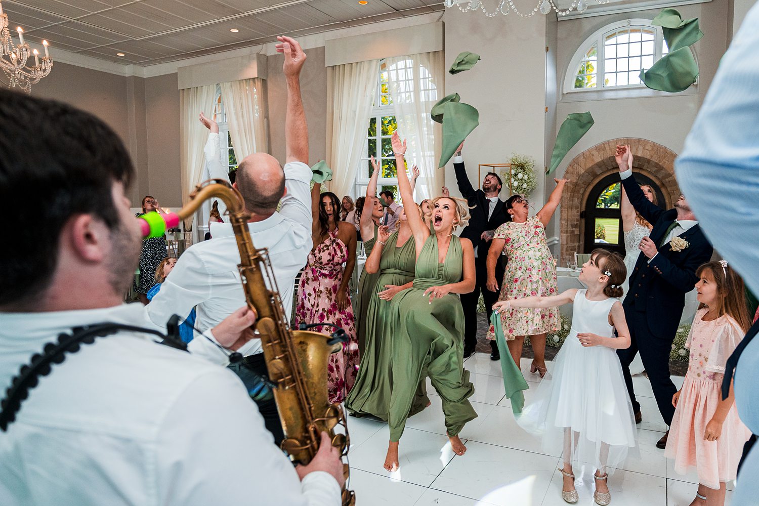 People dancing and celebrating at a lively wedding.