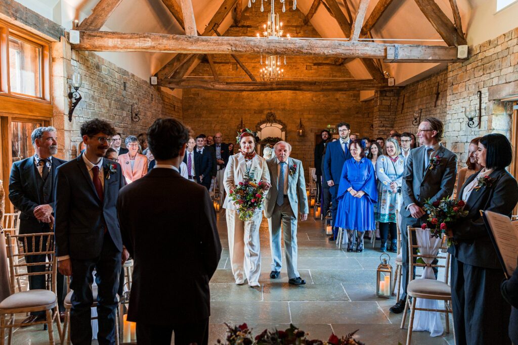 Wedding ceremony in rustic stone barn venue.