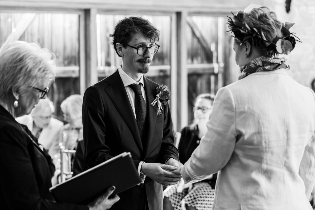 Wedding ceremony with couple exchanging rings.
