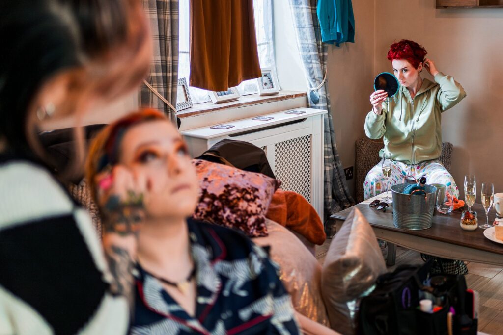 People getting ready with makeup and mirror.