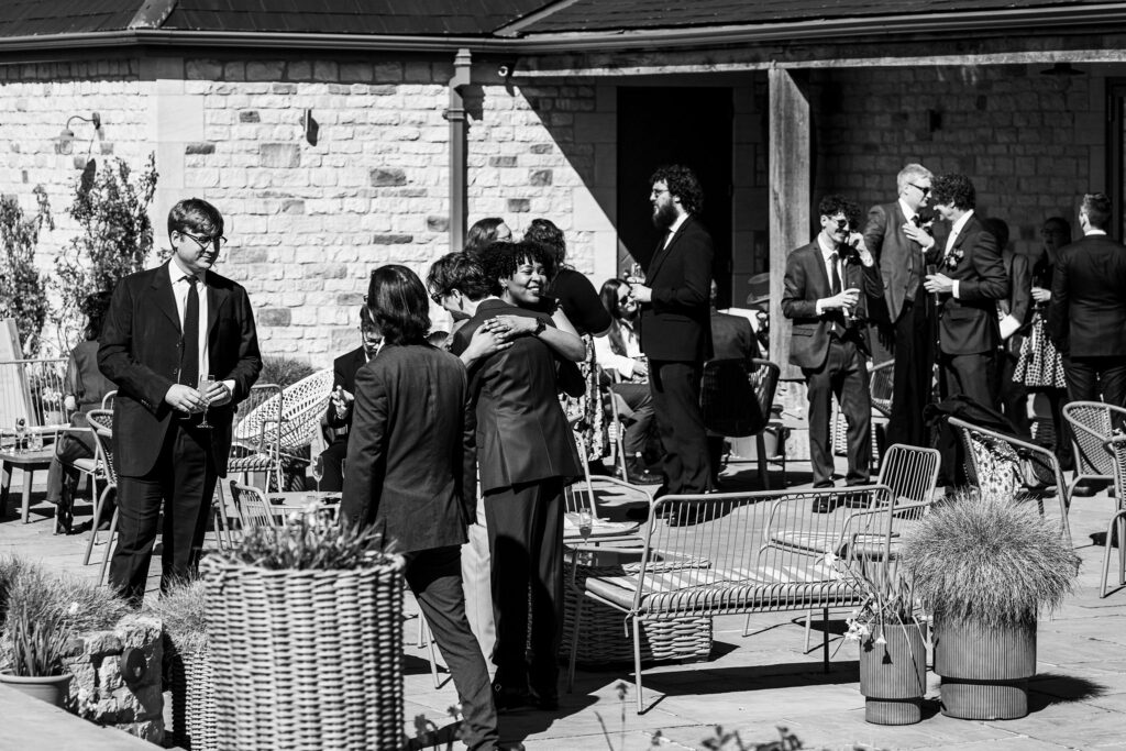People socialising outdoors at formal event.