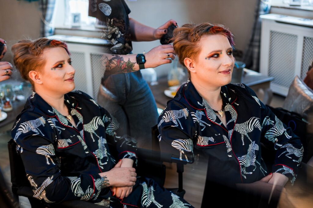 Person styled with short hair and zebra-pattern outfit.