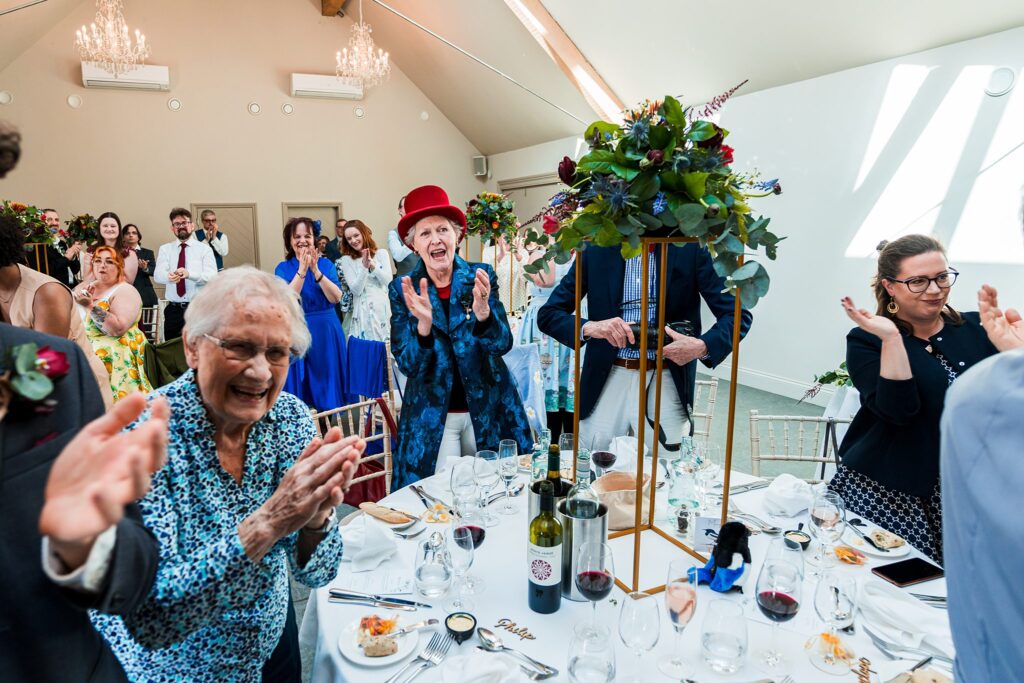 Guests applauding at a joyful gathering.