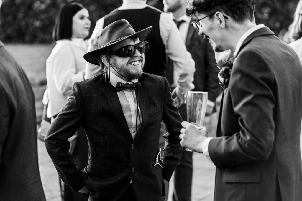 Men in suits laughing at outdoor event