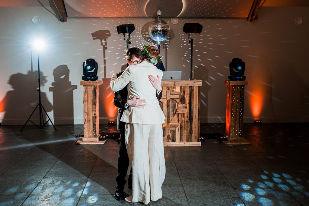 Two people hugging on the dance floor.