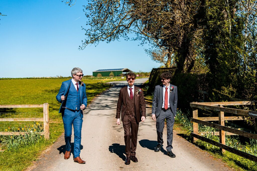 Three men in suits walking outdoors