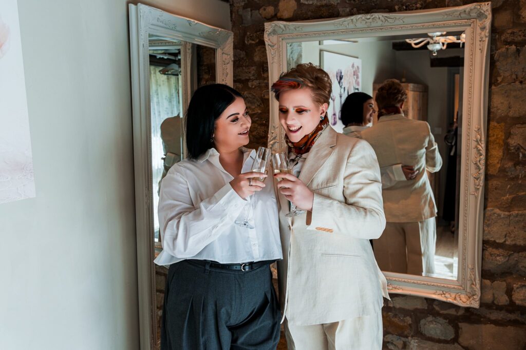 Couple toasting with champagne in mirror reflection.